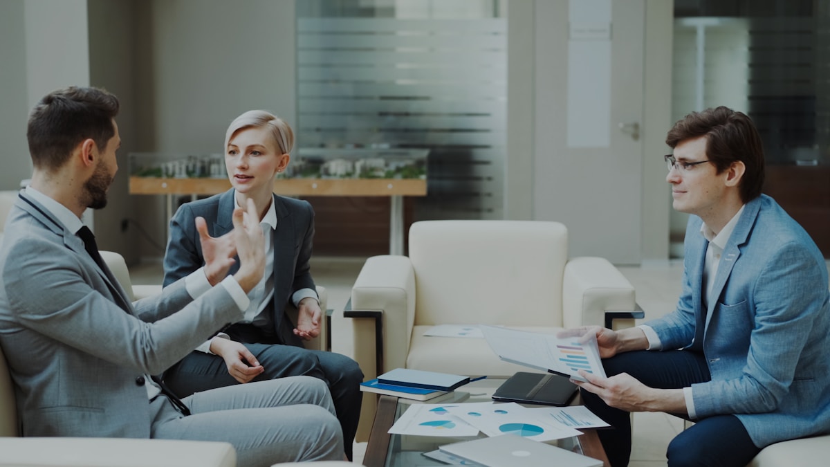 three-business-people-in-a-meeting-3XLrR2ebvn4 collection background image