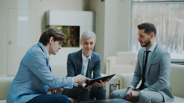 A team reviewing content on a tablet