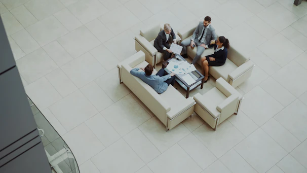 Business people meeting on sofas in a modern lobby.