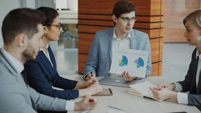 Team discussing charts during a business meeting.