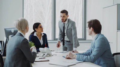 Business professionals in a meeting around a table.