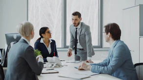Business professionals in a meeting around a table