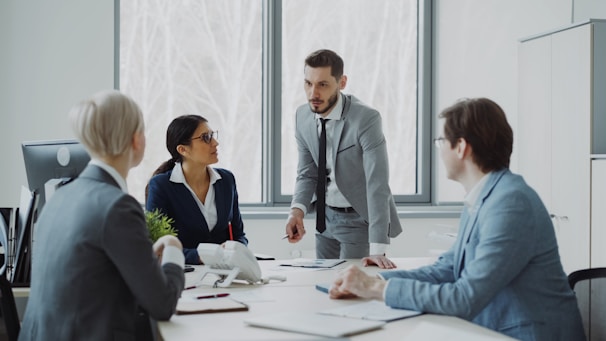 Business professionals in a meeting around a table.