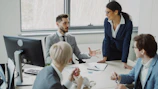 Business professionals collaborating in a modern office meeting