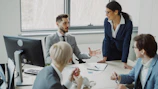 Business professionals collaborating in a modern office meeting.