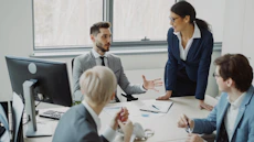 Business professionals collaborating in a modern office meeting.