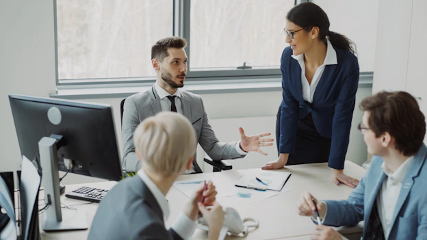 Business professionals collaborating in a modern office meeting.
