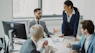 Business professionals collaborating in a modern office meeting.