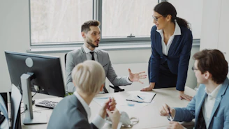 Business professionals collaborating in a modern office meeting.