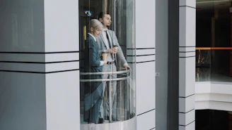 Two business people in a glass elevator