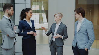 Four business professionals in a meeting discussing ideas.