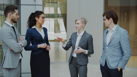 Four business professionals in a meeting discussing ideas.