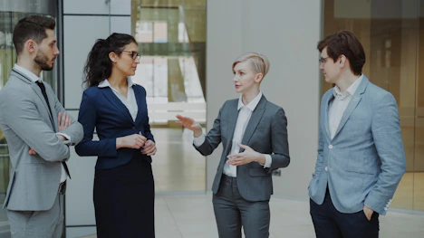 Four business professionals in a meeting discussing ideas.