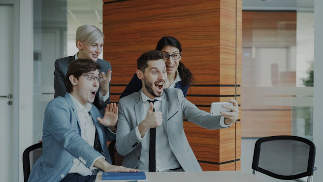 Team celebrates success while taking a selfie