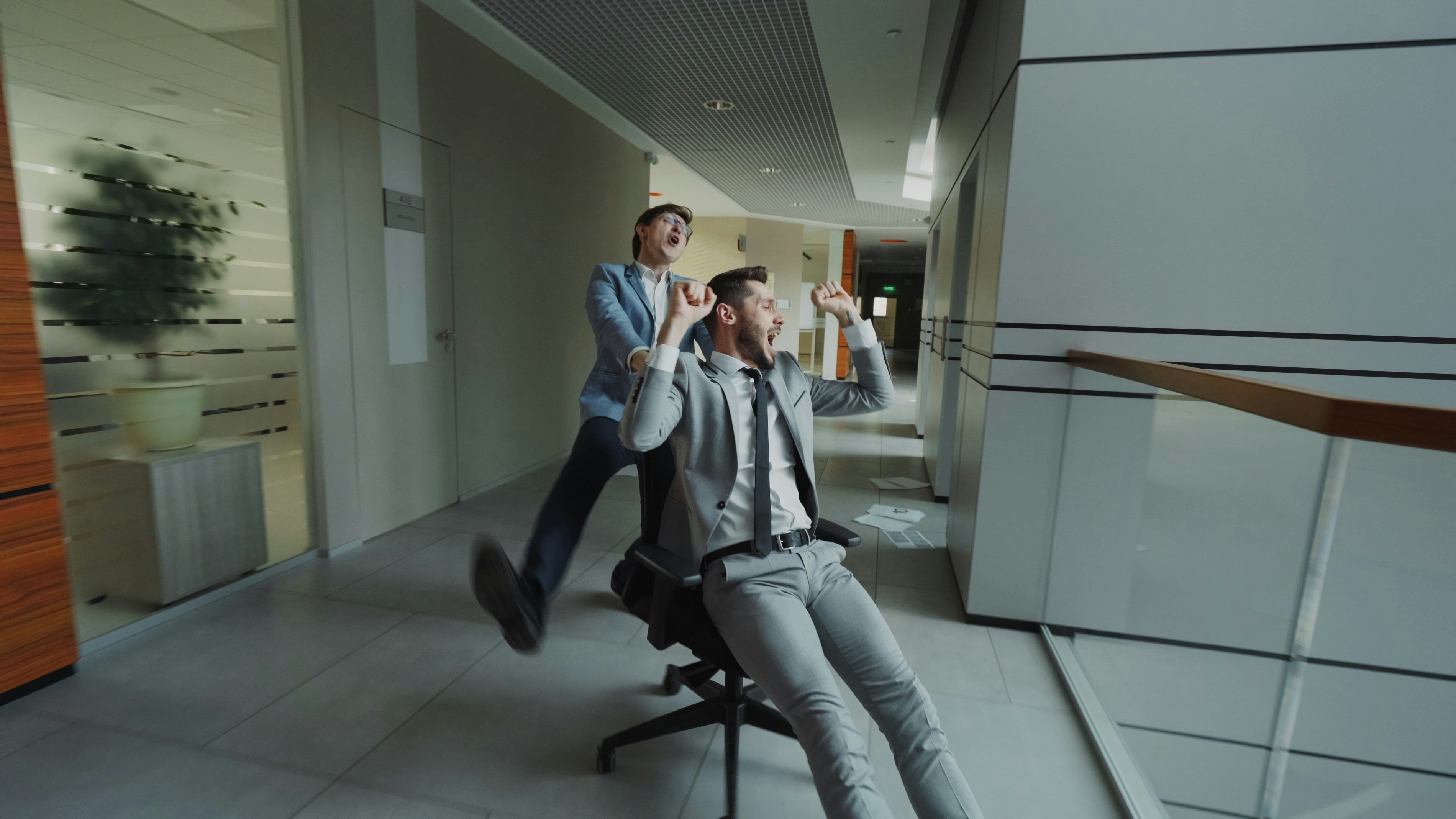 Two businessmen having fun in office hallway