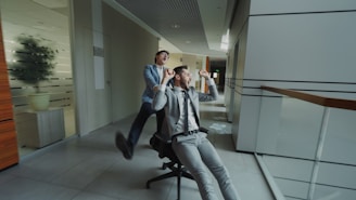 Two businessmen having fun in office hallway