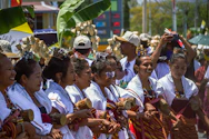 Women in traditional clothing holding small drums