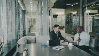 Two businessmen talking at a table
