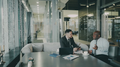 Two businessmen talking at a table