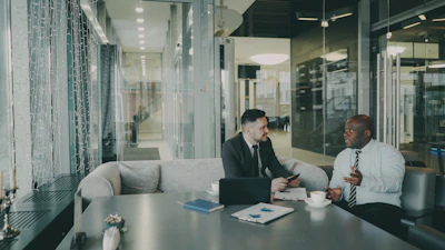 Two businessmen talking at a table