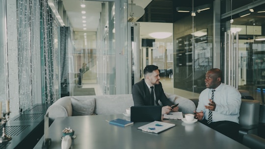 Two businessmen talking at a table