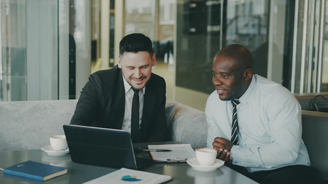 Two African executives working together on a laptop