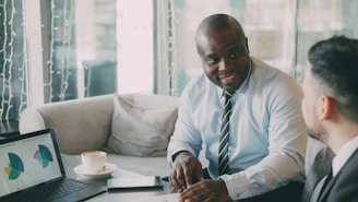 Two businessmen in a meeting with laptop and laptop.