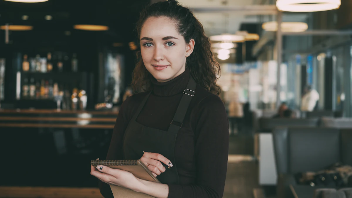Restaurant worker in an apron checking a tablet