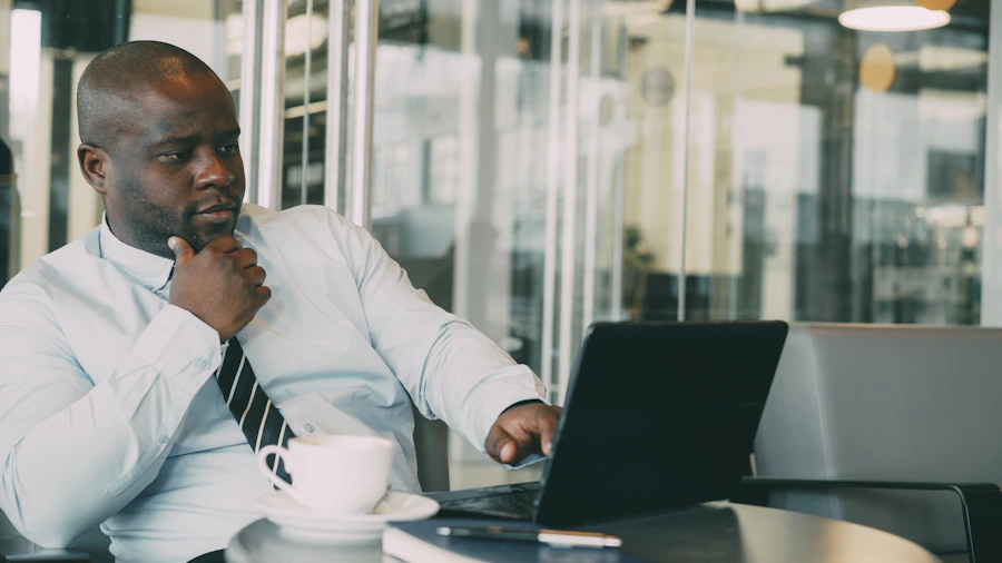 African American professional building his business from a laptop