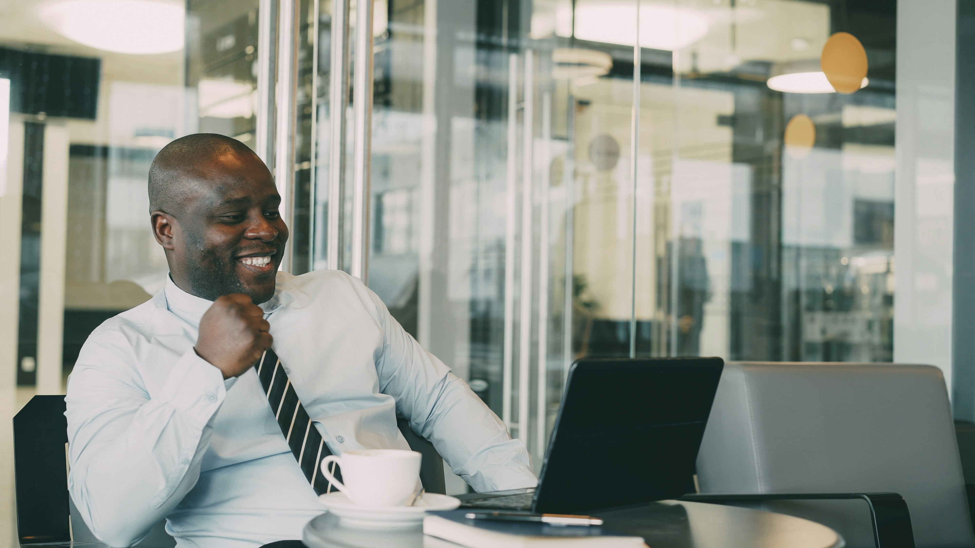 Portrait of hilarious African American businessman in formal clothes smiling