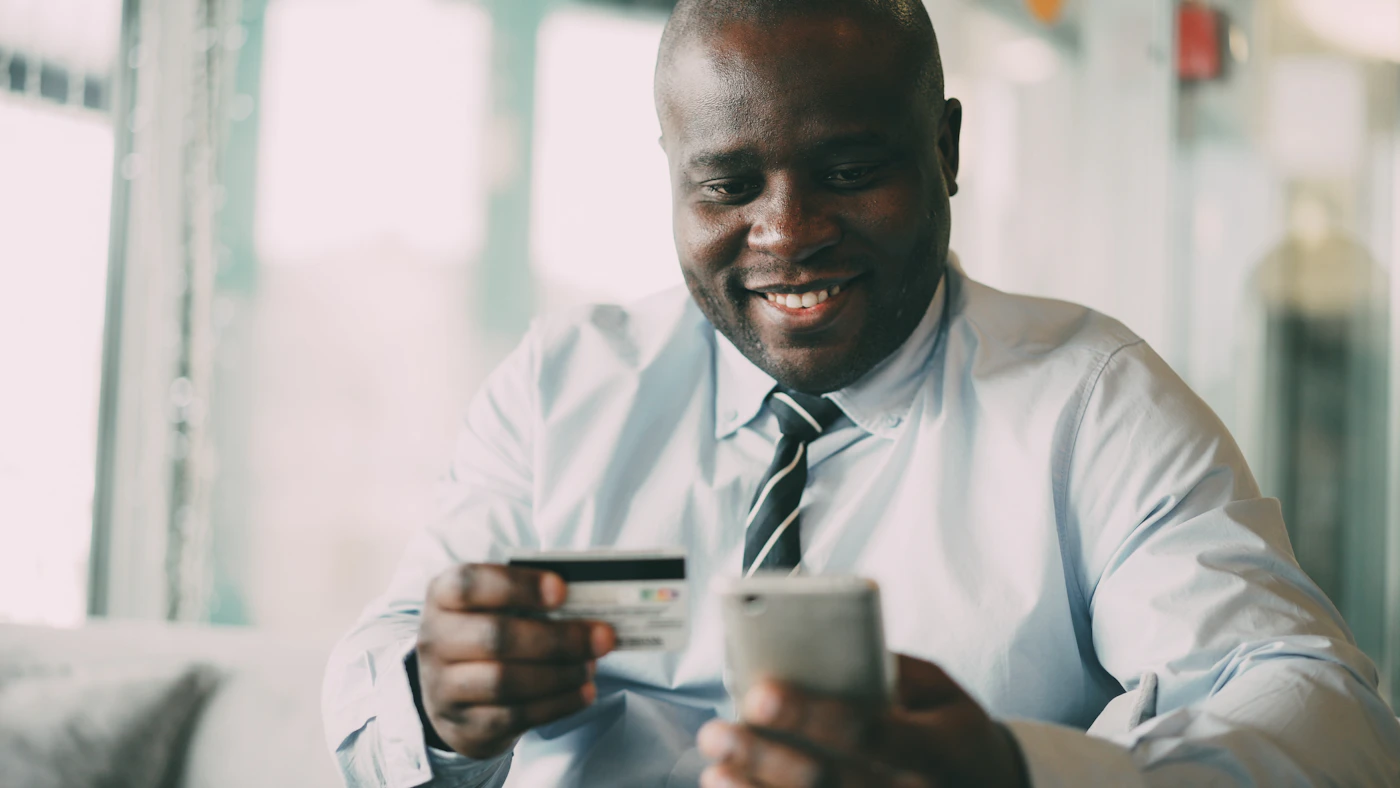 Black businessman smiling during a financial transaction