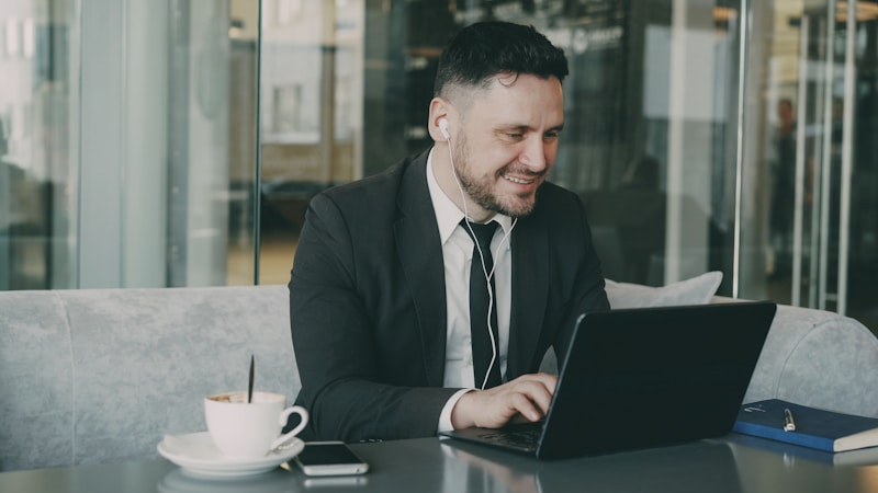 Professional man working on laptop at upscale cafe