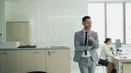 Man in suit thinking in modern office environment.
