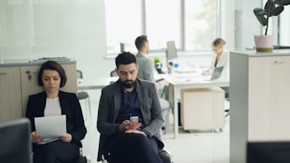 Two people waiting in an office lobby