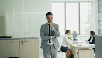 Man in suit thinking in modern office environment