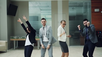 Business people celebrating and dancing in office