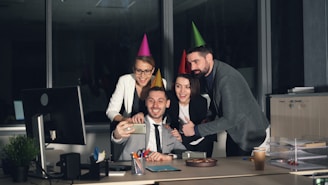 Coworkers taking a selfie at an office party.