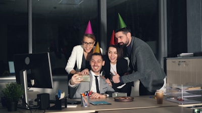 Coworkers taking a selfie at an office party.