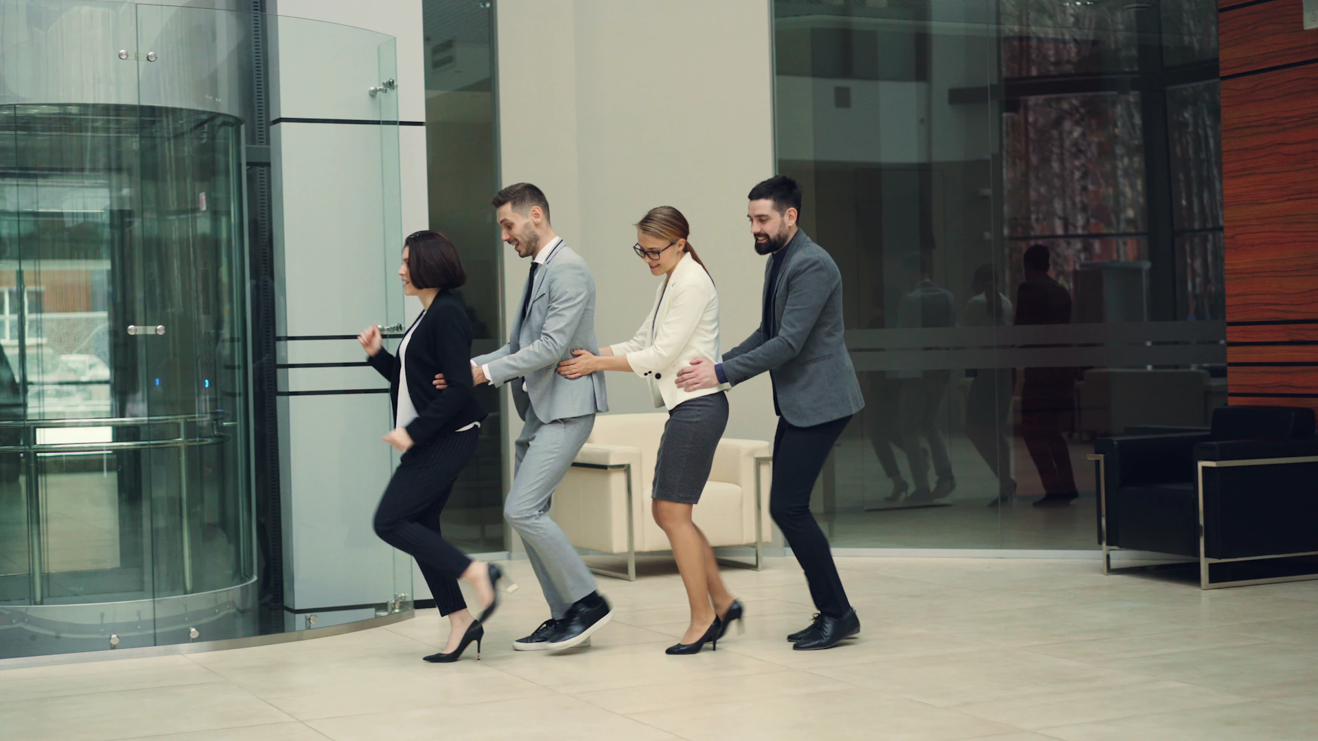 Business people in a line walking into building