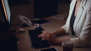 Woman working late at her office desk.