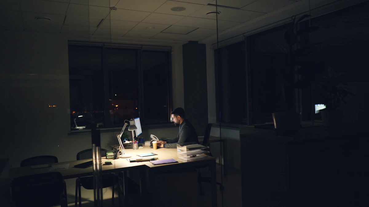 A man in a suit alone at an office desk after dark, lit by the screen, the picture of someone who kept working late to close a gap nobody else can see