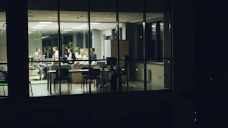 People working late in a modern office at night