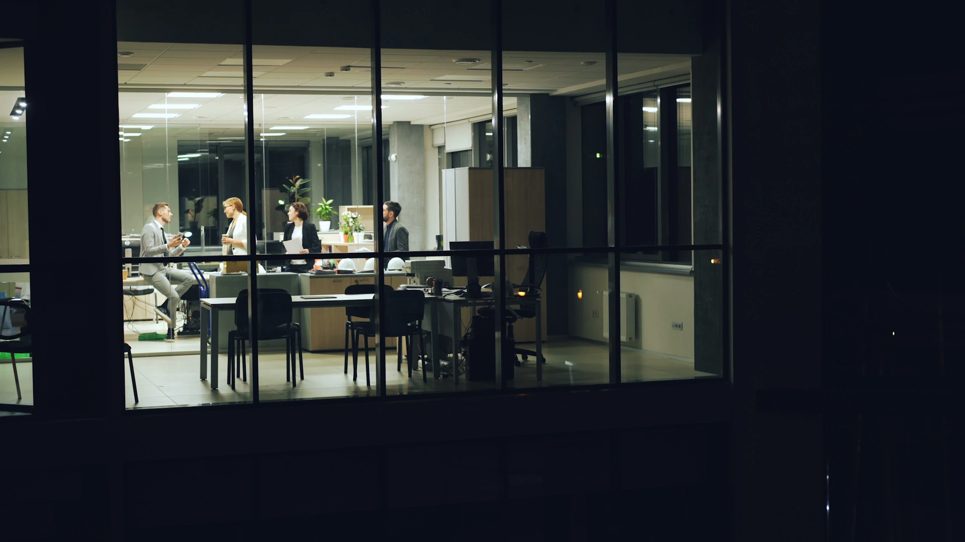 People working late in a modern office at night