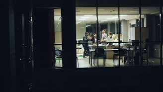 People working late in a modern office at night.