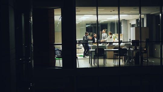 People working late in a modern office at night.