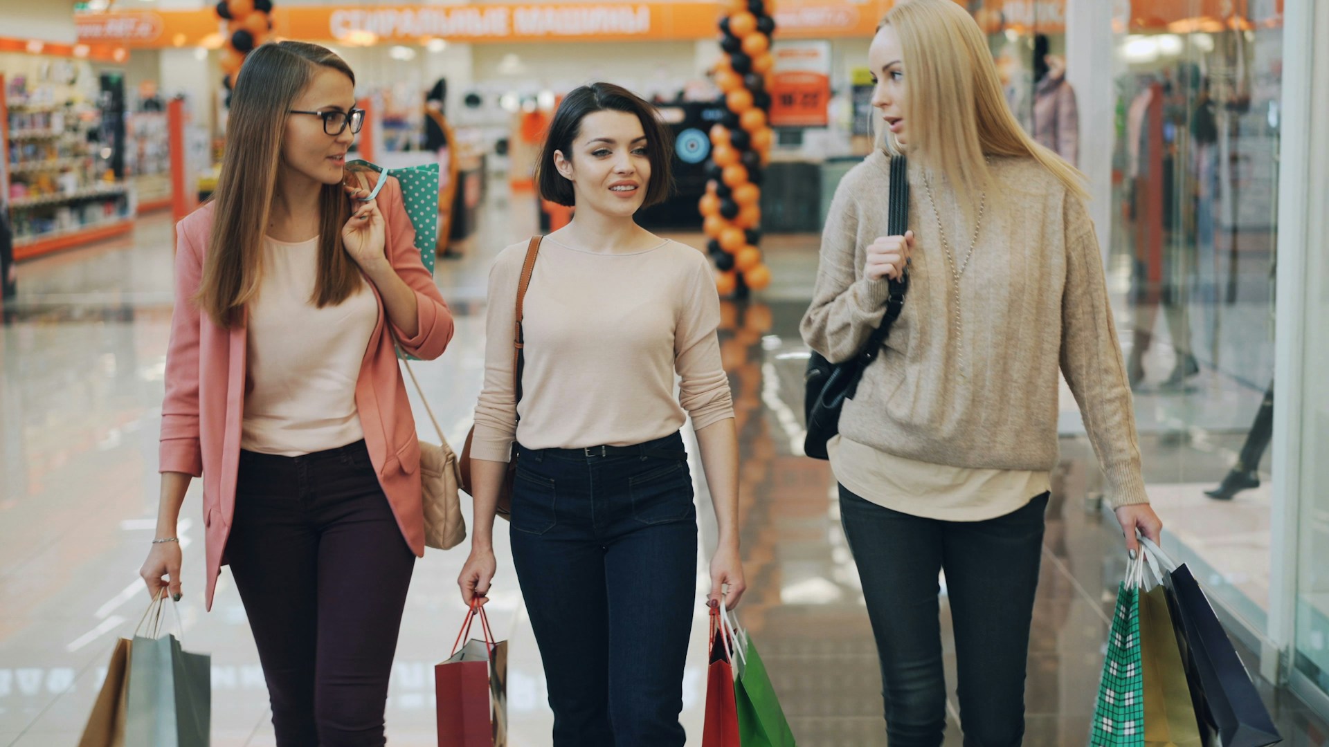 Three women walking with shopping bags