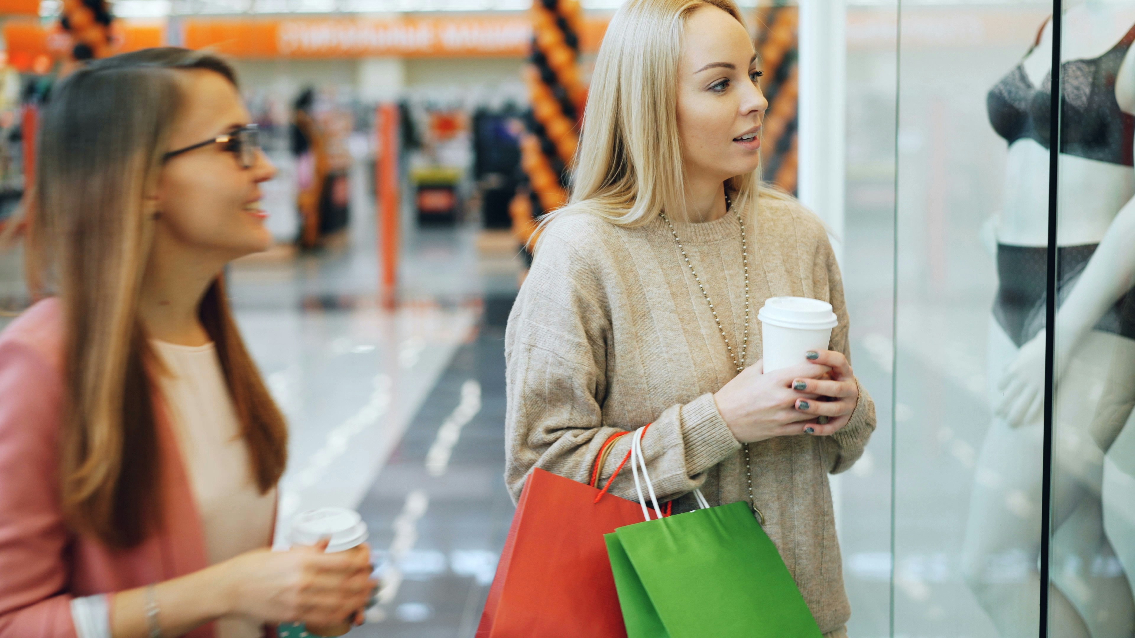 Happy young ladies shopping
