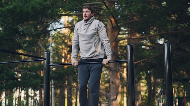 Man exercising on outdoor pull-up bar