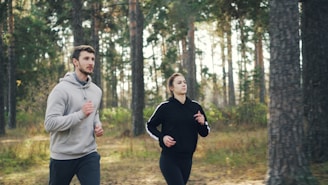 Couple jogging together in a forest