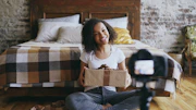 Young woman holding a gift box in front of camera